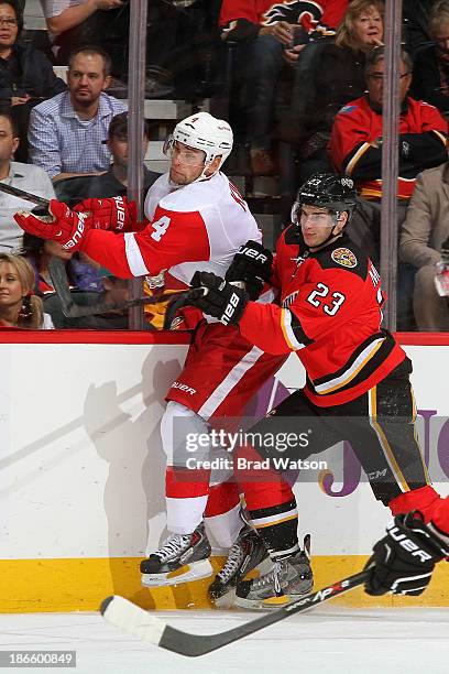 Sean Monahan of the Calgary Flames skates against Jakub Kindl the Detroit Red Wings at Scotiabank Saddledome on November 1, 2013 in Calgary, Alberta,...