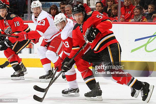 David Jones of the Calgary Flames skates against Pavel Datsyuk of the Detroit Red Wings at Scotiabank Saddledome on November 1, 2013 in Calgary,...