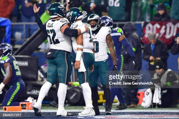 Jalen Hurts of the Philadelphia Eagles celebrates a touchdown with Jason Kelce and D'Andre Swift in the first quarter against the Seattle Seahawks at...