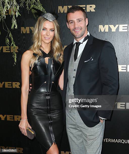 Kris Smith and model Jennifer Hawkins pose on Victoria Derby Day at Flemington Racecourse on November 2, 2013 in Melbourne, Australia.