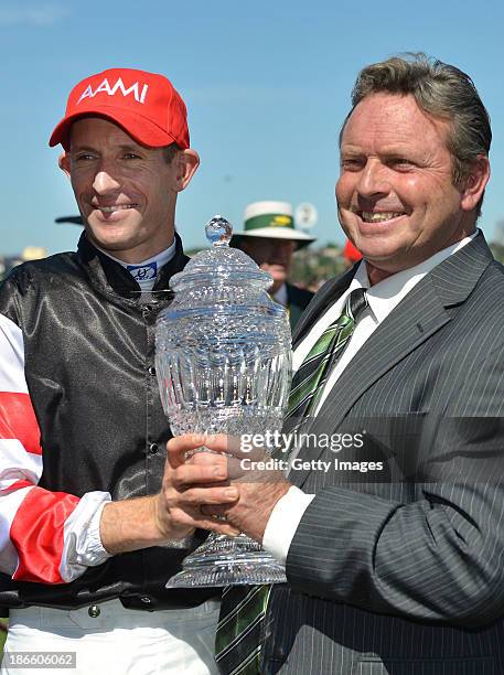 Hugh Bowman and trainer Robbie Laing pose with the trophy after Polanski won Race 6 the AAMI Victoria Derby during Derby Day at Flemington Racecourse...