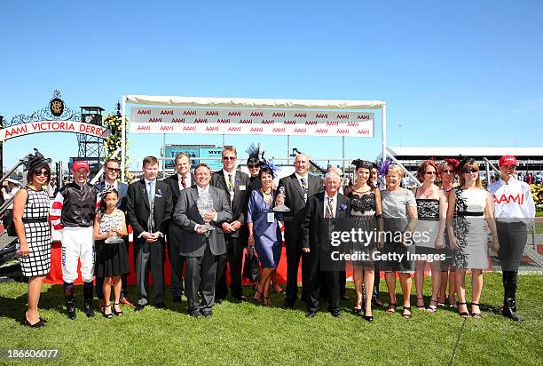 Connections pose with the trophy after Polanski won Race 6 the AAMI Victoria Derby during Derby Day at Flemington Racecourse on November 2, 2013 in...