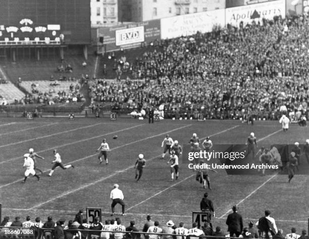 New York University's McNamara throws a pass to NYU end Neemick for a 20 yard gain against Villanova at Yankee Stadium, New York, New York, October...