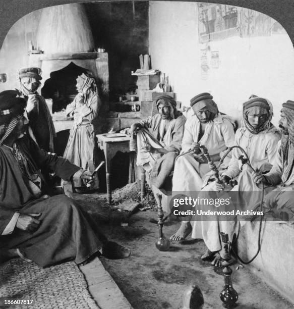 Arab men at their leisure in a coffee house, Mosul, Iraq, late 1890s or early 1900s.