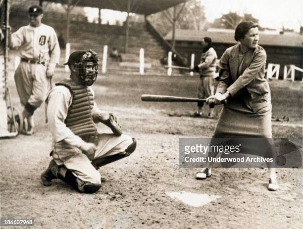 Tennis star Elizabeth Ryan tests her batting eye out at the Detroit Tigers spring training camp, Augusta, Georgia, April 6, 1926. Ty Cobb is an...