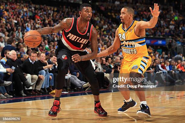 Dorell Wright of the Portland Trail Blazers controls the ball against Andre Miller of the Denver Nuggets at Pepsi Center on November 1, 2013 in...