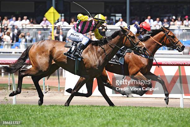 Kerrin McEvoy riding Ruscello defeats Michael Walker riding Let's Make Adeal in Race 3 the Lexus Stakes during Derby Day at Flemington Racecourse on...