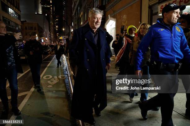 Alec Baldwin is escorted away from a pro-Palestine march by NYPD officers after clashing with protesters in Midtown Manhattan on December 18, 2023 in...