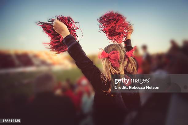 little girl cheering at football game - white pom pom stock pictures, royalty-free photos & images