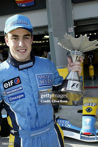 Fernando Alonso of Spain and Renault celebrates after finishing third in the Malaysian Grand Prix at the Sepang International Circuit, Kuala Lumpur,...