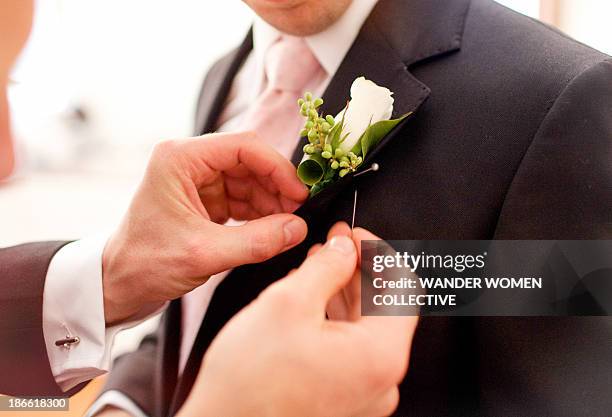 groomsman pinning corsage - corsage foto e immagini stock