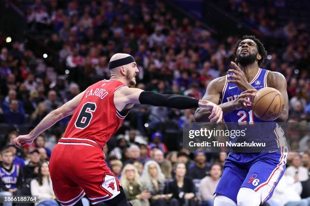 Alex Caruso of the Chicago Bulls strips the ball from Joel Embiid of the Philadelphia 76ers during the fourth quarter at the Wells Fargo Center on...