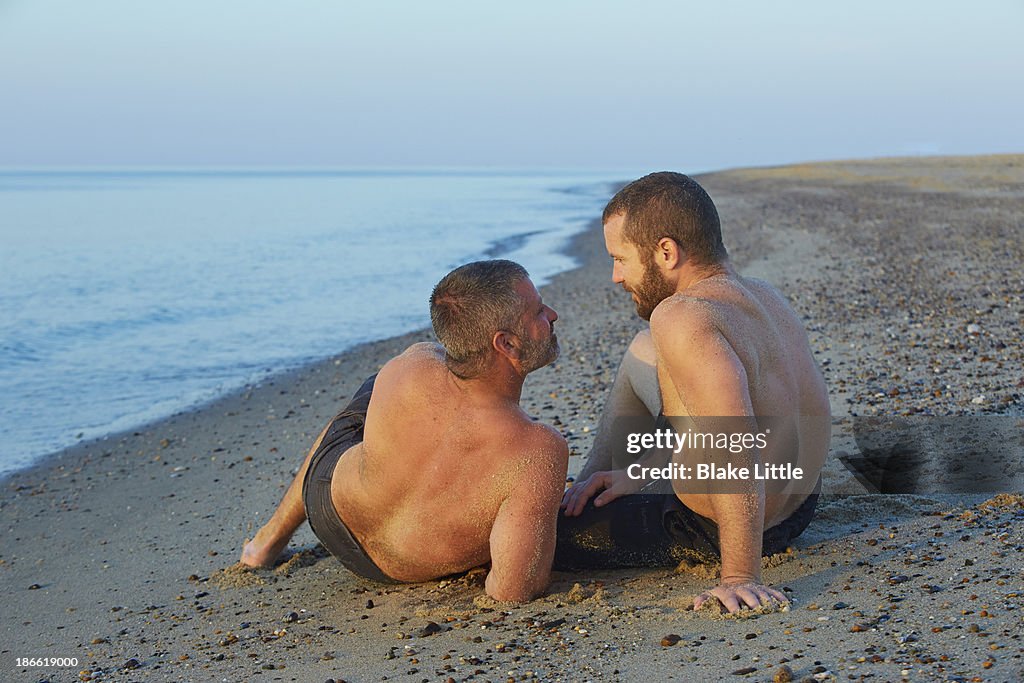 Gay Couple Sitting on Beach