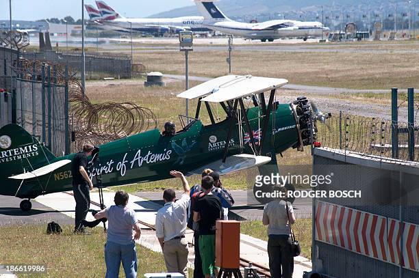 British pilot Tracey Curtis gets ready to take off on a Vintage Boeing Stearman biplane on November 2, 2013 from the Cape Town airport, to fly from...