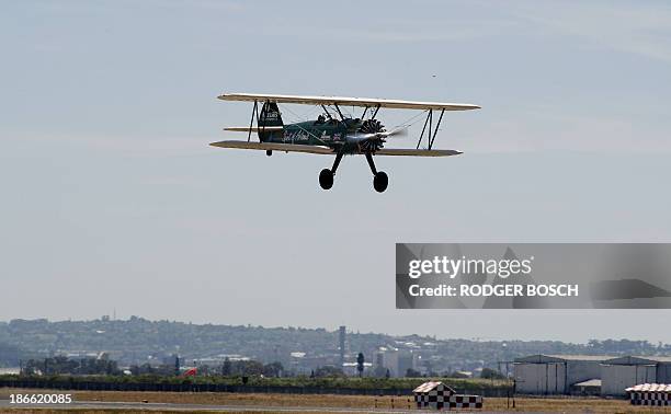 British pilot Tracey Curtis flies on a Vintage Boeing Stearman biplane on November 2, 2013 from Cape Town, to Goodwood, England, to commemorate the...