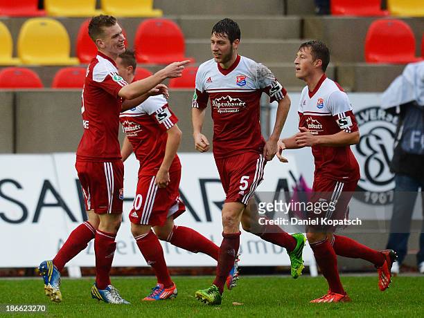 Marius Duhnke of Unterhaching celebrates his team's first goal with team-mates during the third Bundesliga match between SV Elversberg and SpVgg...