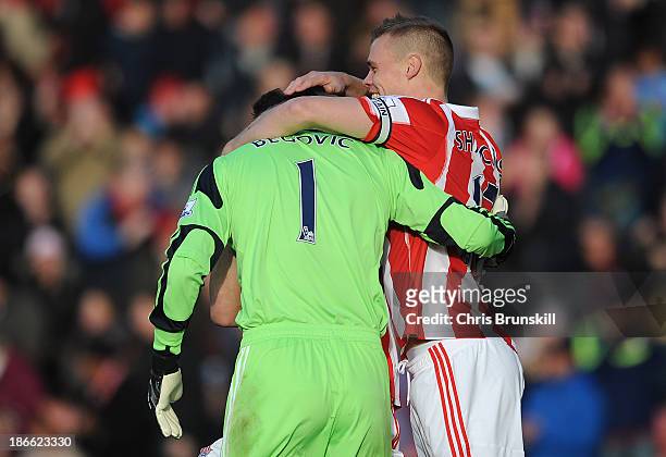 Asmir Begovic of Stoke City is congratulated by team-mate Ryan Shawcross after scoring the opening goal during the Barclays Premier League match...