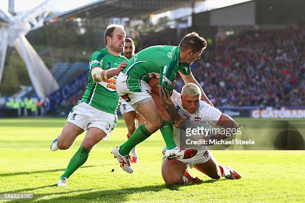 Ryan Hall of England heads for his third try as James Mendeika and Liam Finn fail to stop him of Ireland during the Rugby League World Cup Group A...