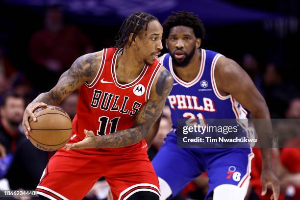 DeMar DeRozan of the Chicago Bulls is guarded by Joel Embiid of the Philadelphia 76ers during the third quarter at the Wells Fargo Center on December...