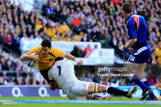 Matt Toomua of Australia scores the opening try despite the tackle from Chris Robshaw of England during the QBE International match between England...