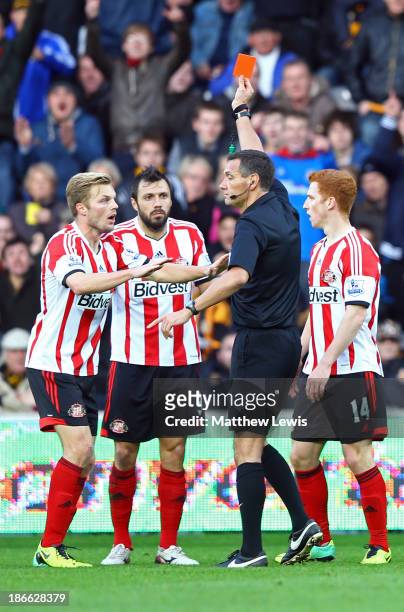 Andrea Dossena of Sunderland is sent off with a red card by referee Andre Marriner as team-mate Sebastian Larsson protests during the Barclays...