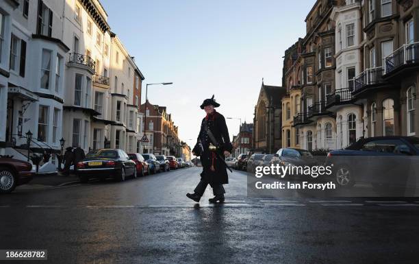 Man dressed as a pirate crosses the street during the Goth weekend on November 2, 2013 in Whitby, England. The Whitby Gothic Weekend that takes place...