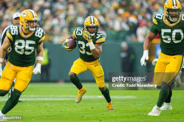 Running Back Aaron Jones of the Green Bay Packers runs the ball during an NFL football game against the Tampa Bay Buccaneers at Lambeau Field on...