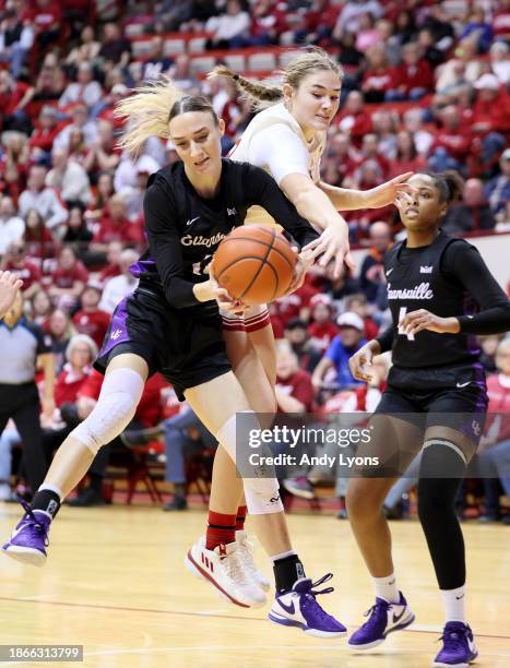 Lilly Meister of the Indiana Hoosiers and Madlena Gerke of the Evansville Purple Aces battle for a rebound in the first half at Simon Skjodt Assembly...