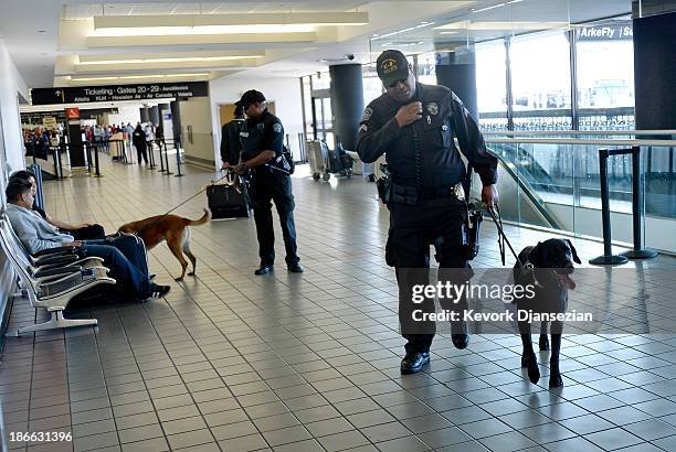 Couple of Los Angeles Police Department officers with their K9 patrol Terminal 2 a day after a shooting that killed one Transportation Safety...