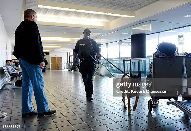 Couple of Los Angeles Police Department officers with their K9 patrol Terminal 2 a day after a shooting that killed one Transportation Safety...