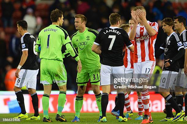 Goalkeeper Artur Boruc of Southampton congratulates Asmir Begovic of Stoke City after his goal during the Barclays Premier League match between Stoke...