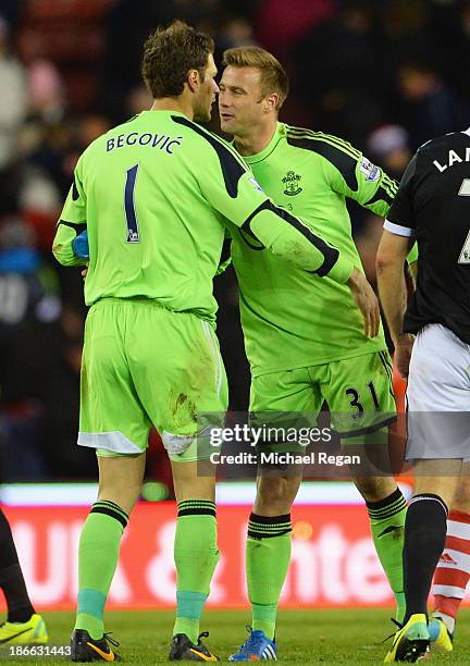 Goalkeeper Artur Boruc of Southampton congratulates Asmir Begovic of Stoke City after his goal during the Barclays Premier League match between Stoke...