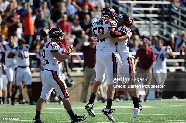 Kicker Cody Journell of the Virginia Tech Hokies receives congratulations from teamates Jack Tyler and Trey Gesh after kicking a 56 yard field goal...