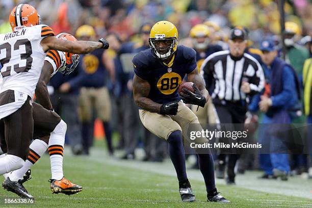 Jermichael Finley of the Green Bay Packers makes the catch and runs with the football for more yards during the game against the Cleveland Browns at...