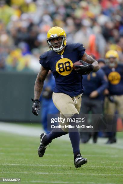 Jermichael Finley of the Green Bay Packers makes the catch and runs with the football for more yards during the game against the Cleveland Browns at...