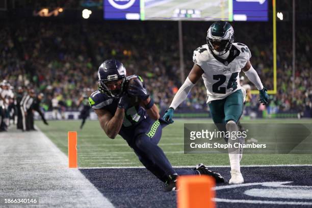 Jaxon Smith-Njigba of the Seattle Seahawks catches a pass for a touchdown passed James Bradberry of the Philadelphia Eagles in the fourth quarter at...