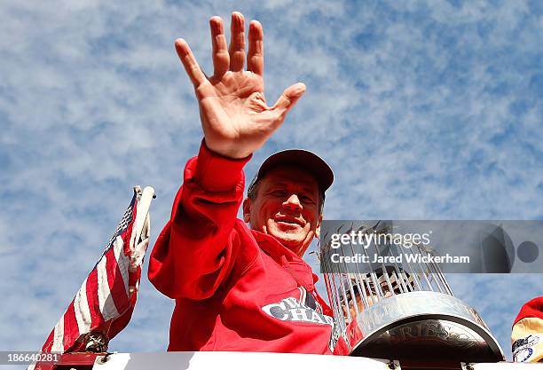 President and Chief Exective Officer Larry Lucchino of the Boston Red Sox holds up the World Series trophy during the World Series victory parade on...