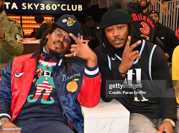 Cam Newton and Brandon Marshall attend the game between the Detroit Pistons and the Atlanta Hawks at State Farm Arena on December 18, 2023 in...