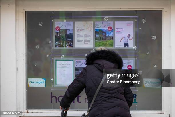 Pedestrian looks in the window of an estate agents in Braintree, UK, on Thursday, Dec. 21, 2023. The downturn in the UK housing market steepened in...