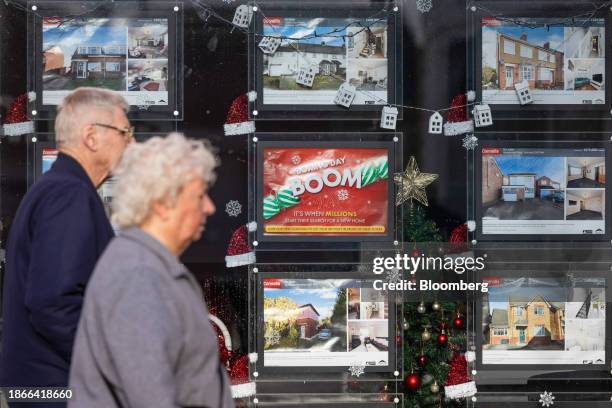 Properties for sale advertised in the window of an estate agents in Braintree, UK, on Thursday, Dec. 21, 2023. The downturn in the UK housing market...