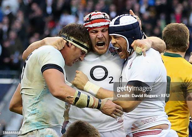 Tom Wood, Ben Morgan and Dave Attwood of England celebrate their victory during the QBE International match between England and Australia at...
