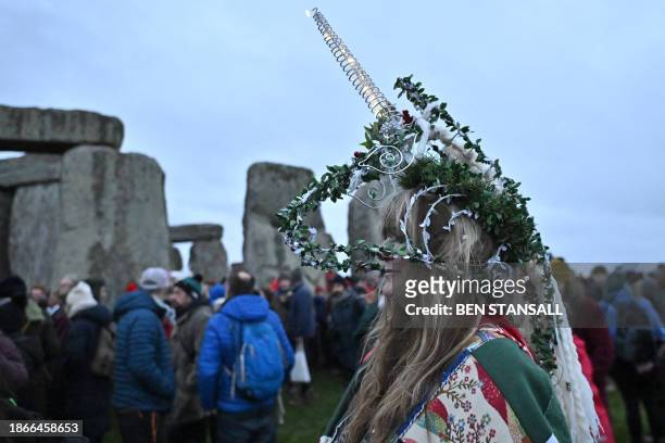 Revellers celebrate the pagan festival of 'Winter Solstice' at Stonehenge in Wiltshire in southern England on December 22, 2023. Followers of...