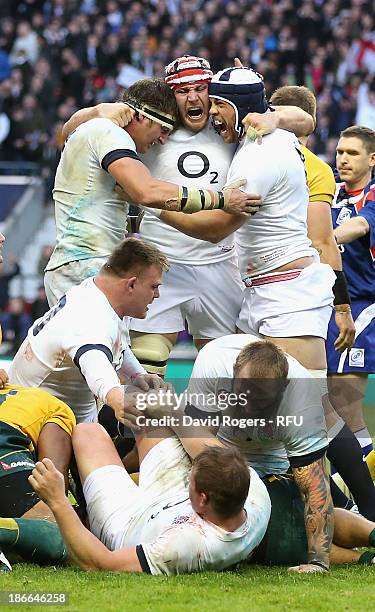 Tom Wood, Ben Morgan and Dave Attwood of England celebrate their victory during the QBE International match between England and Australia at...