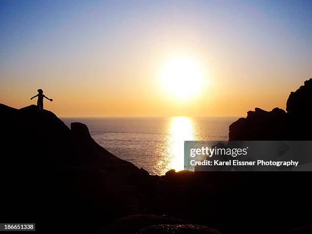 silhouette of girl watching the sunset - cerdeña stock pictures, royalty-free photos & images