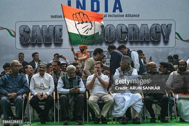 India's Congress party leader Rahul Gandhi and president Mallikarjun Kharge along with other members of parliament take part in a protest in New...