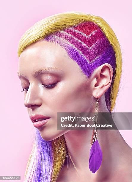 profile of lady with rainbow undercut and dyed hai - corte de pelo con media cabeza rapada fotografías e imágenes de stock