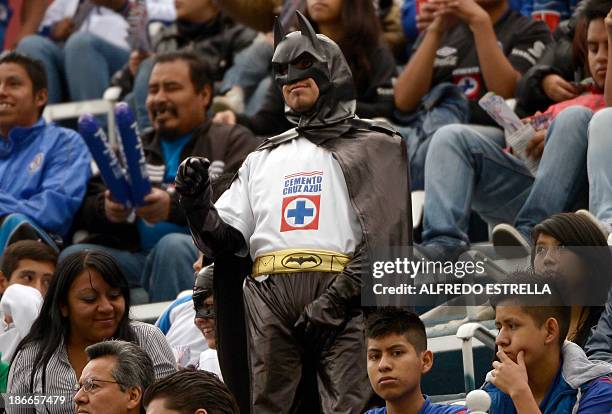 Fan of Cruz Azul dressed like super heroe Batman cheers his team during their Mexican Clausura 2013 football tournament, in Mexico City, on November...