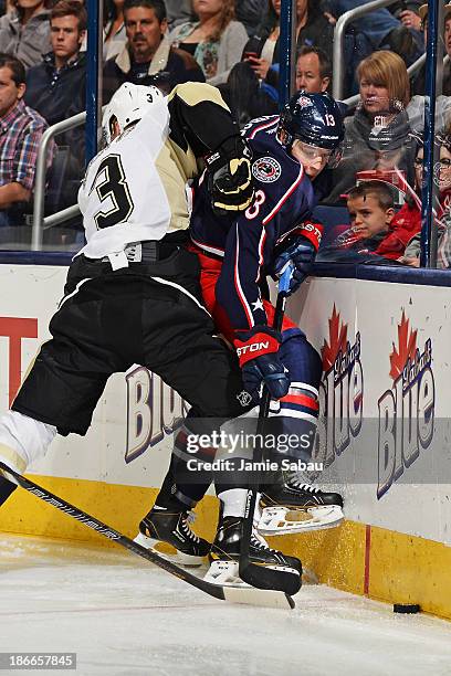 Olli Maatta of the Pittsburgh Penguins pushes Cam Atkinson of the Columbus Blue Jackets against the boards during the third period on November 2,...
