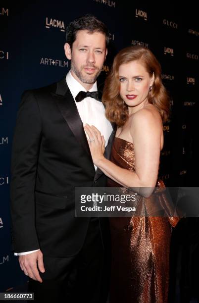 Actors Darren Le Gallo and Amy Adams, wearing Gucci, attend the LACMA 2013 Art + Film Gala honoring Martin Scorsese and David Hockney presented by...