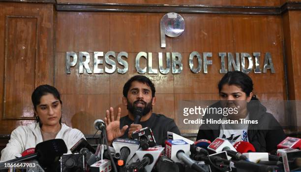 Wrestlers Sakshi Malik, Vinesh Phogat and Bajrang Punia during a press conference after Sanjay Singh, an associate of BJP MP and former chief of...